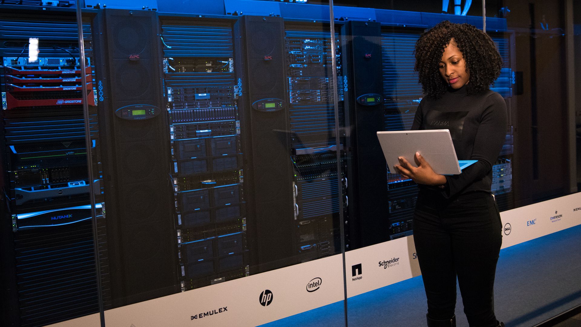 Infrastructure engineer working at a server rack in a modern data centre